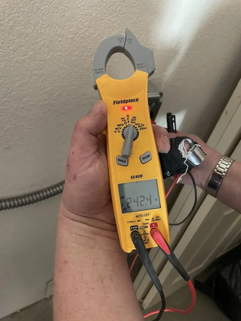 Voltage testing with clamp meter during Recessed Lighting Installation in Grosse Ile